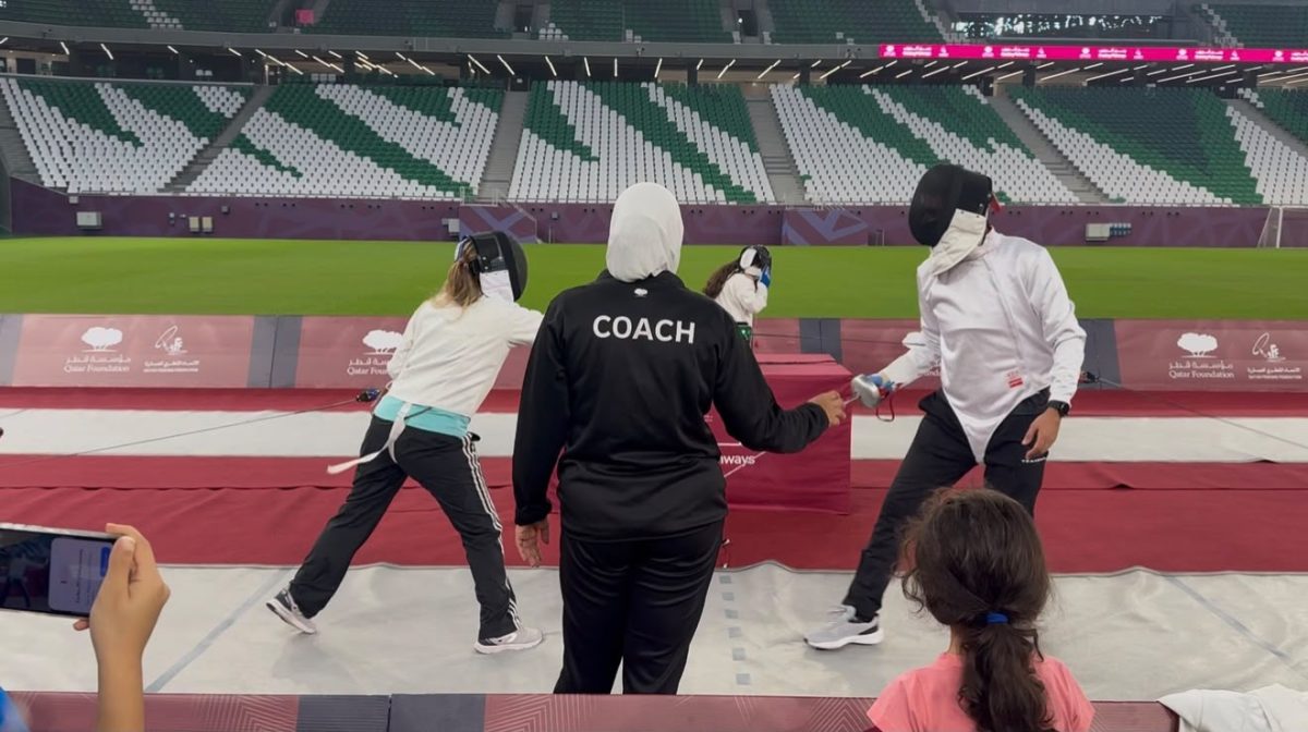 Fencers practice their technique under the guidance of a coach during ‘Touché: International Fencing Day’ at Education City Stadium.